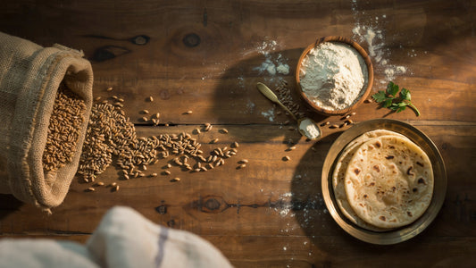 Khapli wheat flour (Emmer wheat) grains and fresh rotis on rustic wooden table