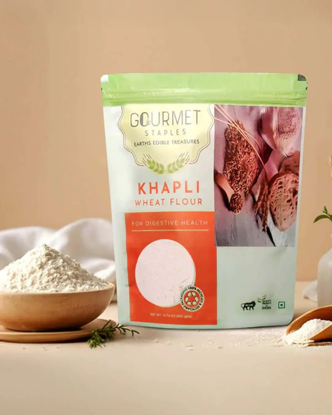 Khapli wheat flour pouch on table with bowl and scoop of flour, high-fiber healthy atta
